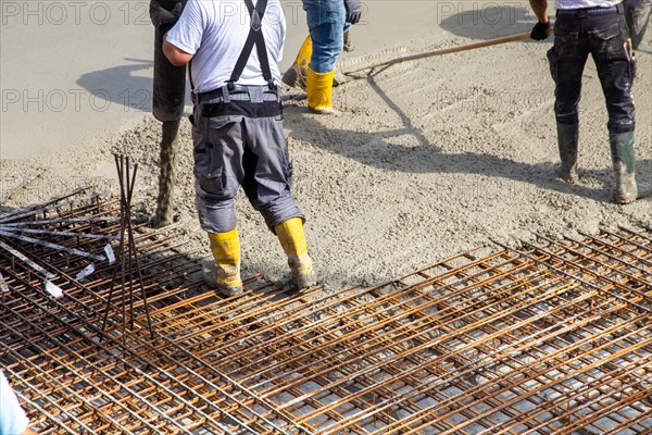 Delivery of ready-mixed concrete to the construction site of a residential building in a new development area in Mutterstadt, Palatinate