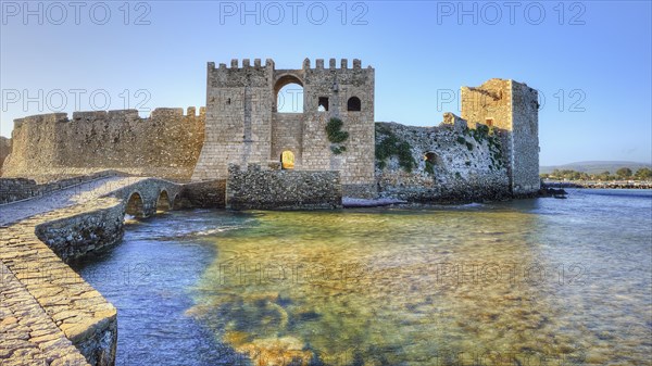 Old castle walls reflected in the water with sea view in the background, sea fortress Methoni, Peloponnese, Greece, Europe