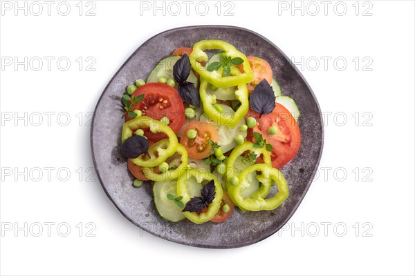 Vegetarian salad from green pea, tomatoes, pepper and basil isolated on white background. Top view, close up