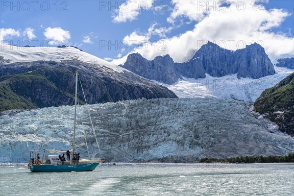 Sailing yacht between ice floes in Pia Bay in front of Pia Glacier, Alberto de Agostini National Park, Avenue of the Glaciers, Chilean Arctic, Patagonia, Chile, South America