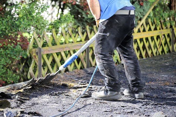 Roofers remove old bitumen and roof waterproofing