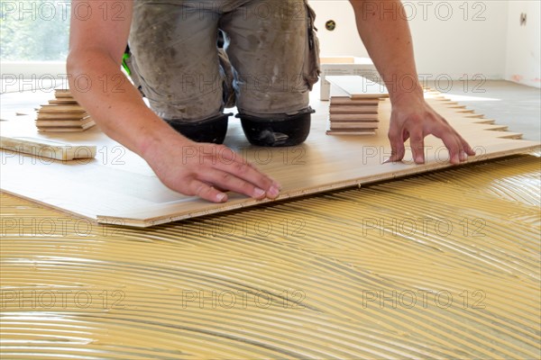 Craftsmen laying herringbone parquet professionally