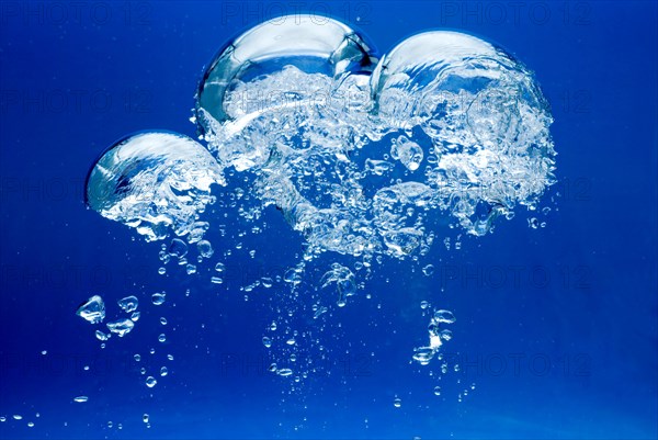 Bright Air bubbles, blue background in an aquarium