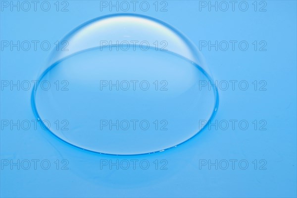 A large soap bubble on light blue water