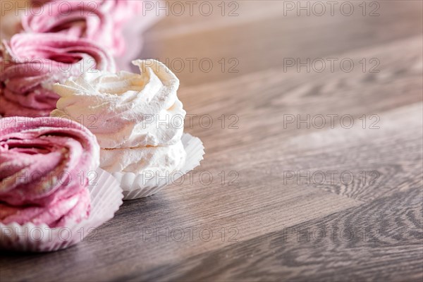 Pink and white homemade marshmallows on a gray wooden background. selective focus