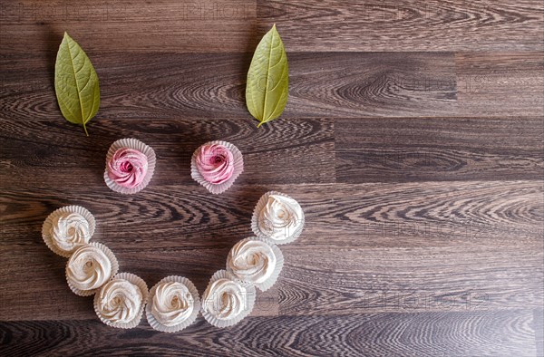 Pink and white homemade marshmallows on a gray wooden background. selective focus