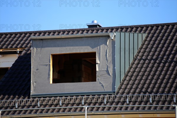 Roofer working on a new dormer window