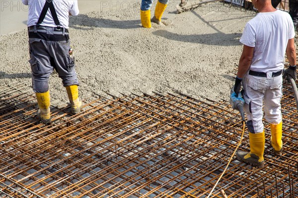 Delivery of ready-mixed concrete to the construction site of a residential building in a new development area in Mutterstadt, Palatinate