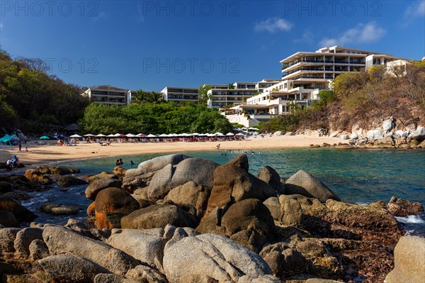 People bathing at Playa Arrocito in front of the Cosmo Residence, La Crucecita, Baja de Huatulco, South Pacific Coast, State of Oaxaca, Mexico, Central America