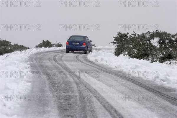 Blue rental car in the snow of the highest mountain Roque de los Muchachos altitude 2400 m, La Palma, Canary Islands, Spain, Europe