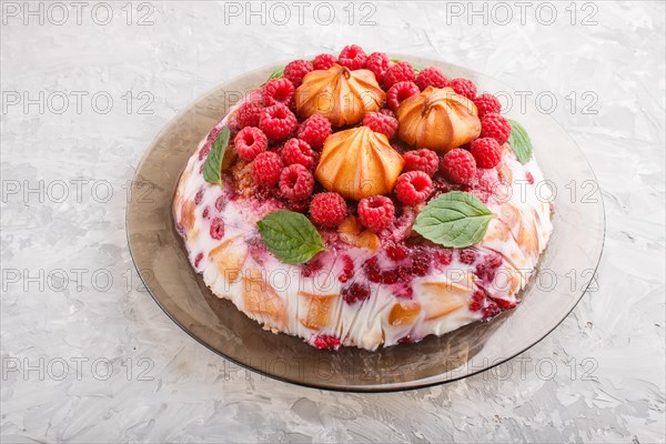 Homemade jelly cake with milk, cookies and raspberry on a gray concrete background. side view, close up