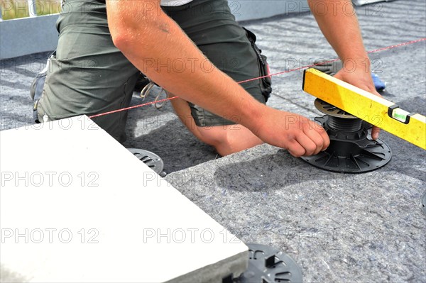 Worker lays paving stones