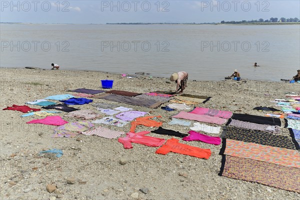 Washing clothes in the Irrawaddy, Myanmar, Asia