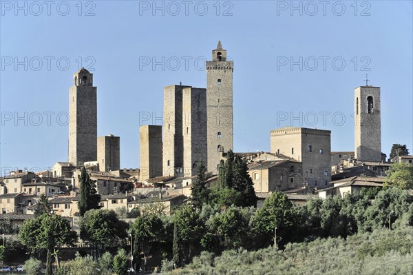 Town view, town scape, cityscape of San Gimignano in autumn, gender towers, countryside, in fall, fields of olive trees, wineyards, Tuscany, Italy, Europe