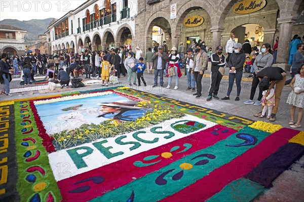 Peruvian people look at a floor painting in the Plaza de Armas, Ayacucho, Huamanga province, Peru, South America