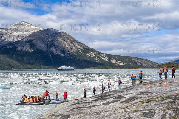 Passengers of the cruise ship Stella Australis board an inflatable boat between ice floes at Pia Glacier, Alberto de Agostini National Park, Avenue of Glaciers, Chilean Arctic, Patagonia, Chile, South America