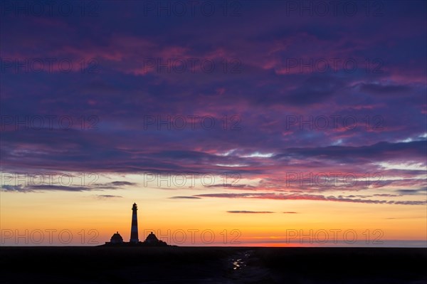 Lighthouse Westerheversand silhouetted against blue sunset sky, Westerhever, Wadden Sea National Park, North Frisia, Schleswig-Holstein, Germany, Europe