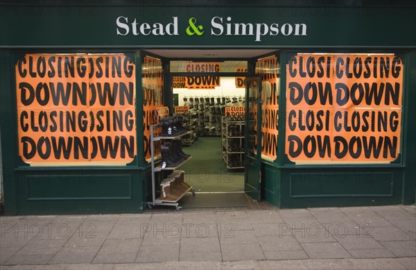 Stead and Simpson shoe shop closing down posters in window, Woodbridge, Suffolk, England, United Kingdom, Europe