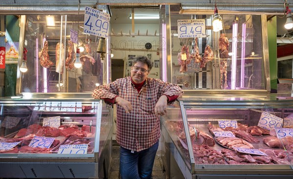Butcher, meat trader posing proudly in front of his market stall, display of fresh meat, butchery, food, Kapani market, Vlali, Thessaloniki, Macedonia, Greece, Europe