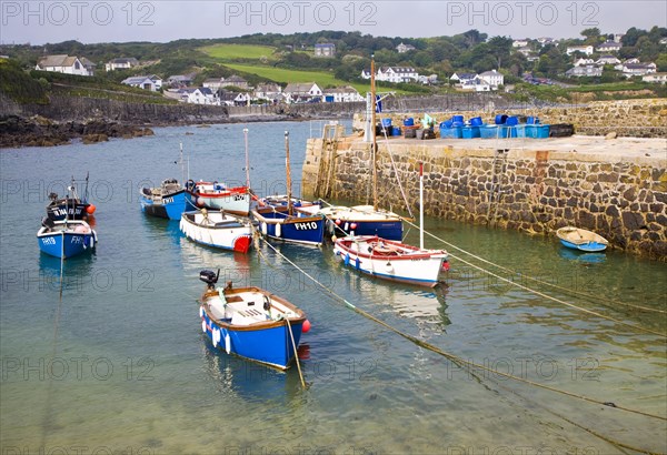 Small fishing boats in the harbour at the village of Coverack on the Lizard peninsula, Cornwall, England, United Kingdom, Europe