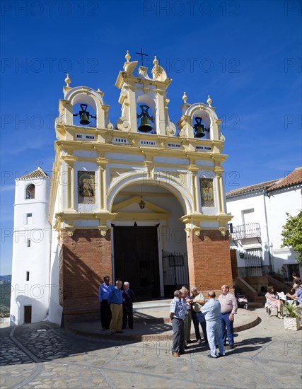 Men gather by the baroque church of San Juan at Zahara de la Sierra, Spain Sunday 13 October 2013 after the National Day holiday