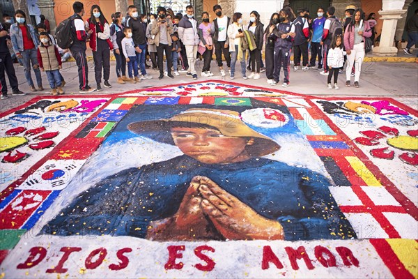 Peruvian people look at a floor painting in the Plaza de Armas, Ayacucho, Huamanga province, Peru, South America