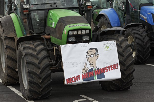 Sign with drawn Minister of Agriculture Cem Oezdemir on a tractor, farmer protests, demonstration against policies of the traffic light government, abolition of agricultural diesel subsidies, Duesseldorf, North Rhine-Westphalia, Germany, Europe