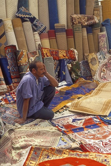Resting carpet seller at market in Torre del Mar, Andalusia, Spain, Southern Europe. Scanned thumbnail slide, Europe