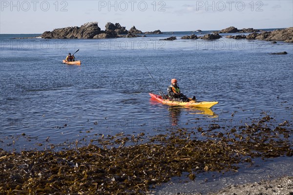 Two men fishing from kayak canoes off Lizard Point, Cornwall, England, United Kingdom, Europe