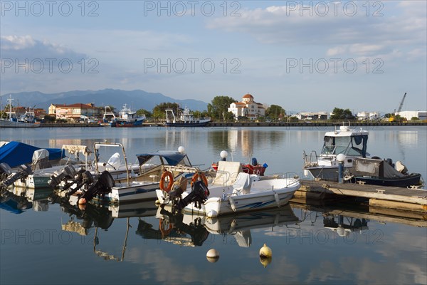 Motorboats are moored at a small jetty in a quiet harbour with a mountain panorama in the background, harbour and view of Porto Lagos, Xanthi, Eastern Macedonia and Thrace, Greece, Europe