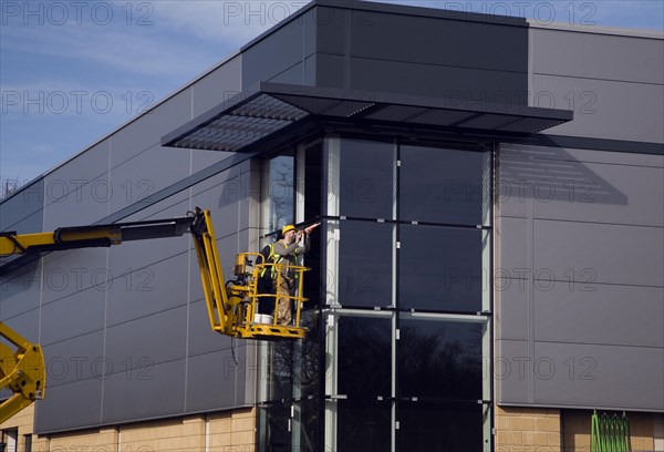 Cherry picker crane at construction site, UK