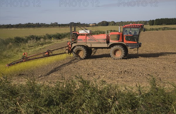 Farm machinery spraying Glyphosate herbicide on an arable field near Hollesley, Suffolk, England, United Kingdom, Europe