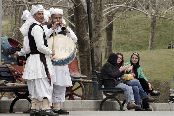 Musicians in traditional dress play music in a park in Tehran, Iran, woman, 14.03.2019, Asia