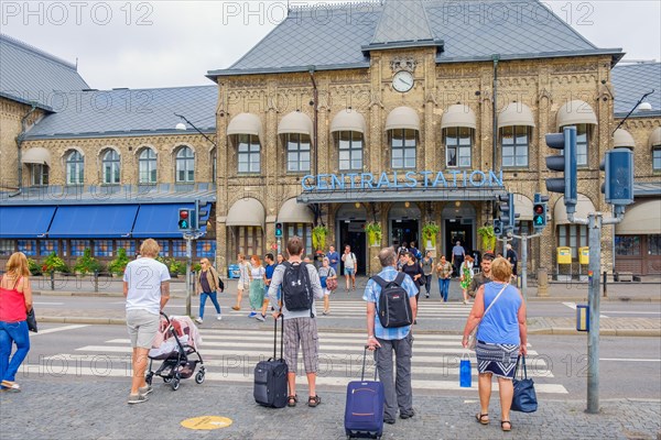 People at a pedestrian crossing on their way to the railway station to travel, Gothenburg, Sweden, Europe