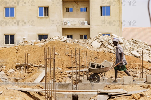 Young men working on a construction site in Nigeria, 06.02.2024