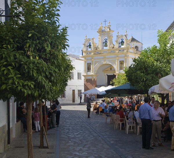 People gather in cafes and by the baroque church of San Juan at Zahara de la Sierra, Spain Sunday 13 October 2013 after the National Day holiday