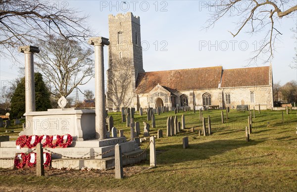 War memorial with poppy wreaths at St John the Baptists church, Snape, Suffolk, England, United Kingdom, Europe