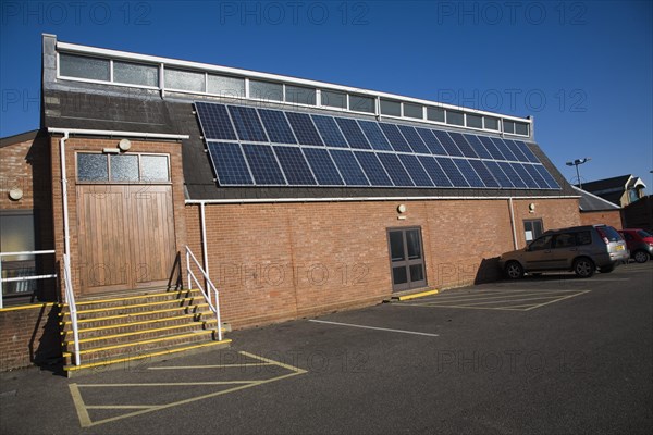 Rooftop array solar panels on community centre building, Woodbridge, Suffolk, England, United Kingdom, Europe