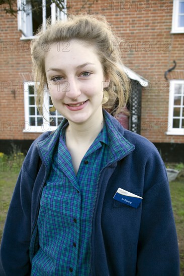 Model released teenage girl in uniform for her job in a Co-operative shop, UK