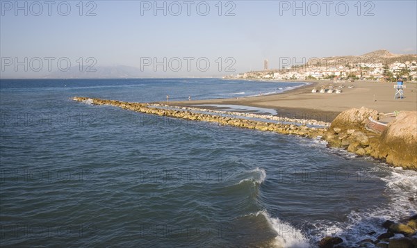 Coastline with breakwater groyne, waves and beach at La Cala del Moral, Malaga, Spain, Europe