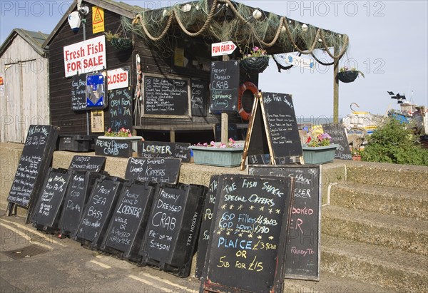 Blackboard offers for fresh fish on sale outside beach shed, Aldeburgh, Suffolk, England, United Kingdom, Europe