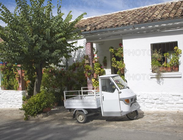 Small three wheeled truck vehicle outside village house Grazalema, Spain, Europe