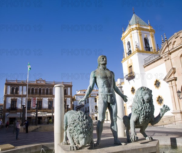 Church and sculpture of man with two lions, Plaza del Socorro, Ronda, Spain, Europe