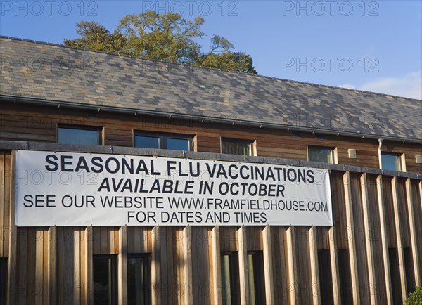Seasonal flu vaccinations available poster sign on Framfield health centre, Woodbridge, Suffolk, England, United Kingdom, Europe
