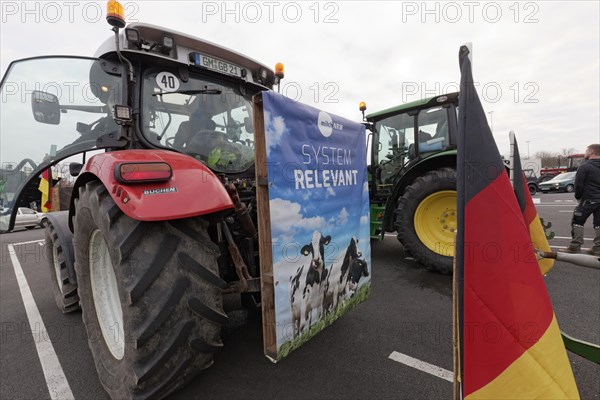 Poster with dairy cows and writing Systemrelevant on a tractor, farmer protests, demonstration against policies of the traffic light government, abolition of agricultural diesel subsidies, Duesseldorf, North Rhine-Westphalia, Germany, Europe