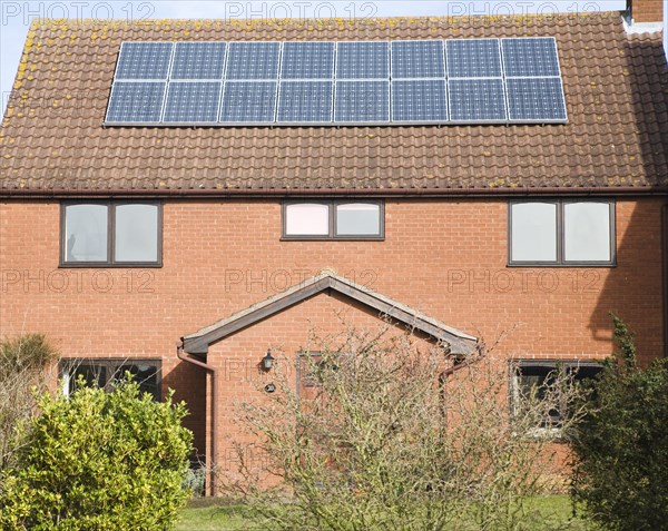 Photovoltaic solar panels on roof of modern suburban house, Martlesham, Suffolk, England, United Kingdom, Europe