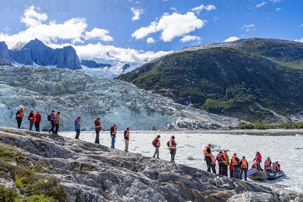 Passengers of the cruise ship Stella Australis board an inflatable boat between ice floes at Pia Glacier, Alberto de Agostini National Park, Avenue of Glaciers, Chilean Arctic, Patagonia, Chile, South America