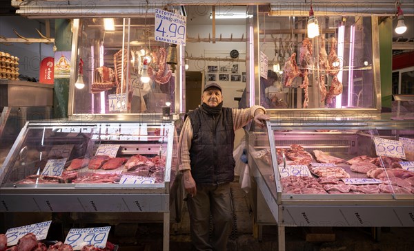 Butcher, meat trader posing proudly in front of his market stall, display of fresh meat, butchery, food, Kapani market, Vlali, Thessaloniki, Macedonia, Greece, Europe