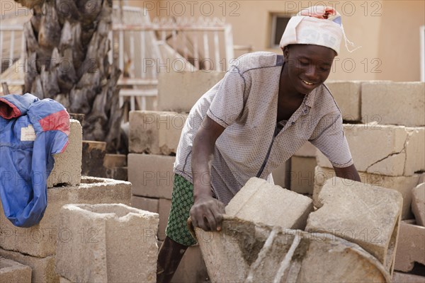 Boy working on a construction site in Nigeria, 06/02/2024