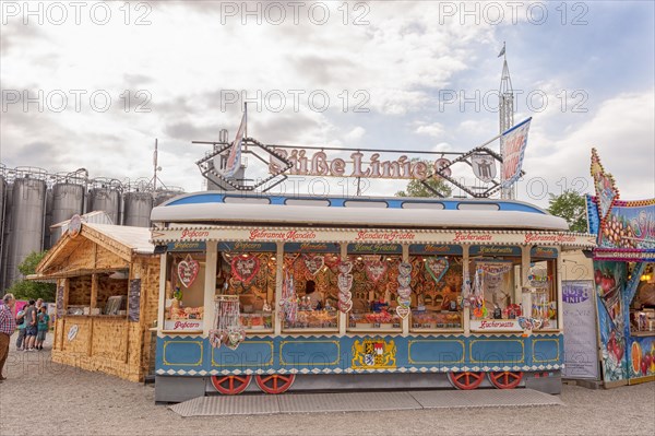 Folk festival and funfair stand, shape of Bavarian tram, almonds, sweets, children, moated castle am Inn, Bavaria